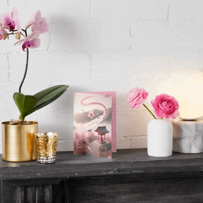 Anime-style illustration of a drifting sakura petal caught in a breeze, spiraling toward a peaceful shrine, symbolizing renewal, healing, and gentle encouragement.