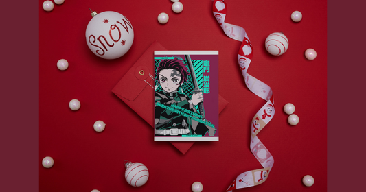 Person writing personalized message in anime greeting card surrounded by holiday decorations and additional cards ready to send