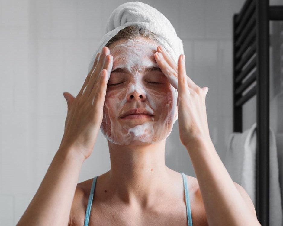 a woman with a towel on her head and a face mask on