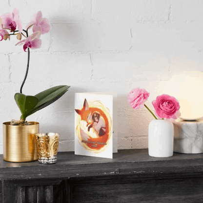 Anime-style illustration of a gentle fox spirit curled beside a resting figure, surrounded by a warm glow that symbolizes a protective aura of healing.