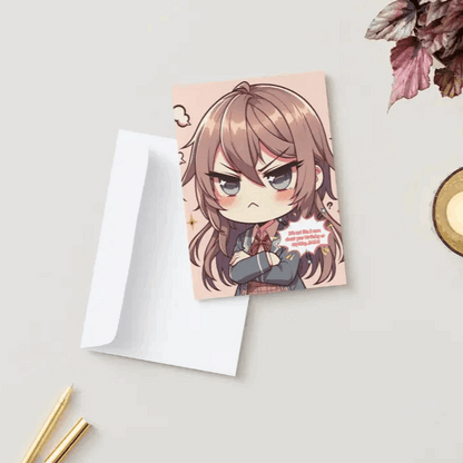 A chibi character with crossed arms, a blush, and a pout, embodying tsundere energy on an Anime Humor Card. The front text reads: “It’s not like I care about your birthday or anything… BAKA!