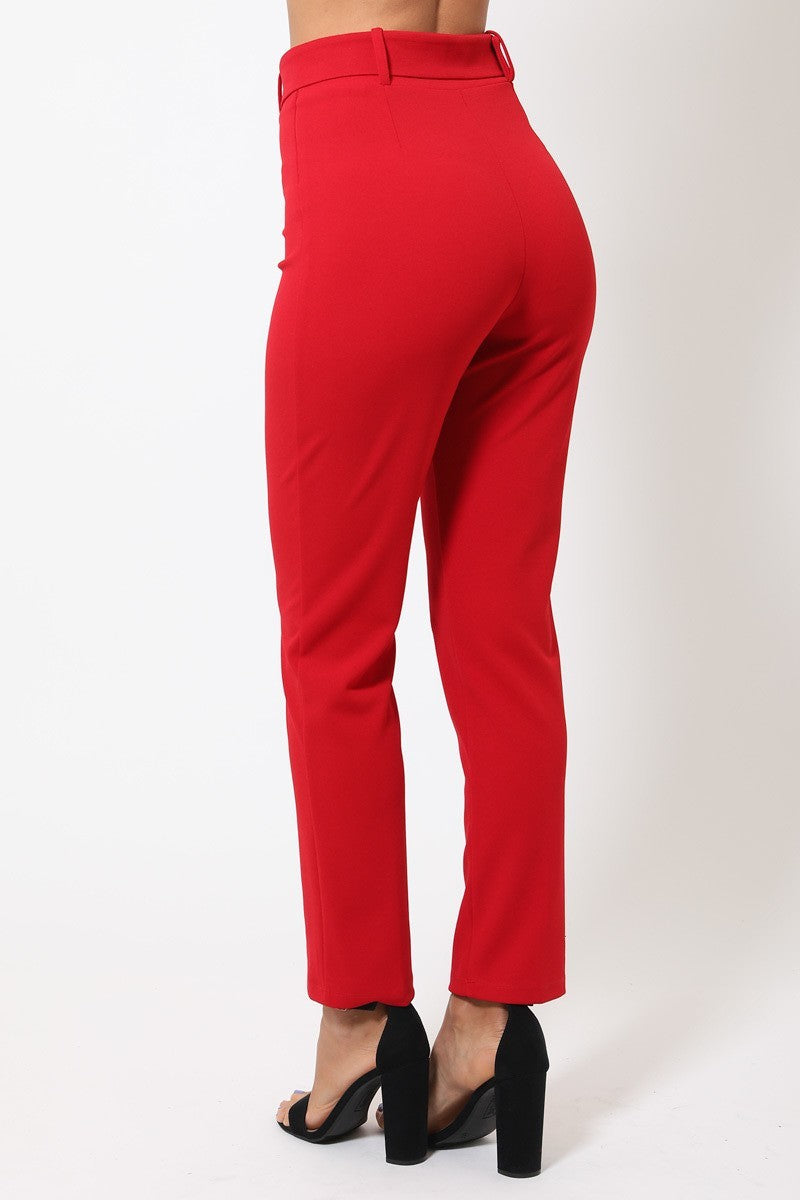a woman in a red pants and heels