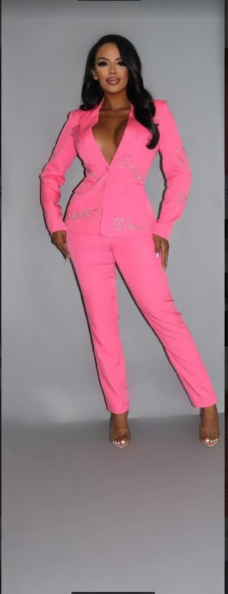 a person in a pink suit posing for a picture