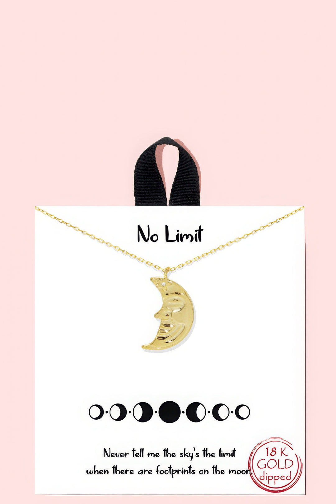 a card with a gold crescent pendant on it