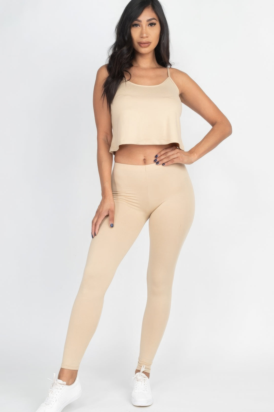 a woman in a beige crop top and leggings