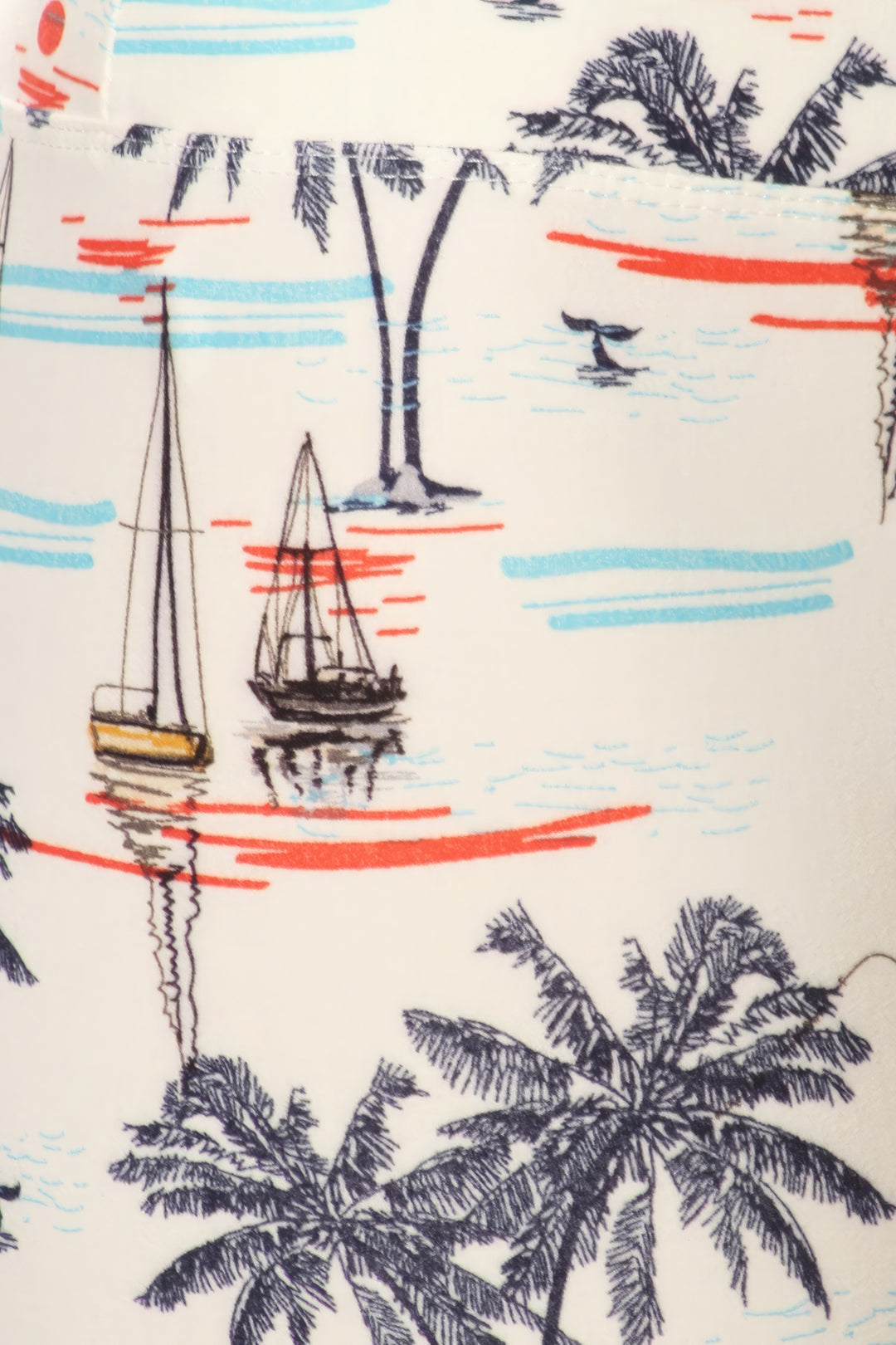 a close up of a shirt with a boat and palm trees on it