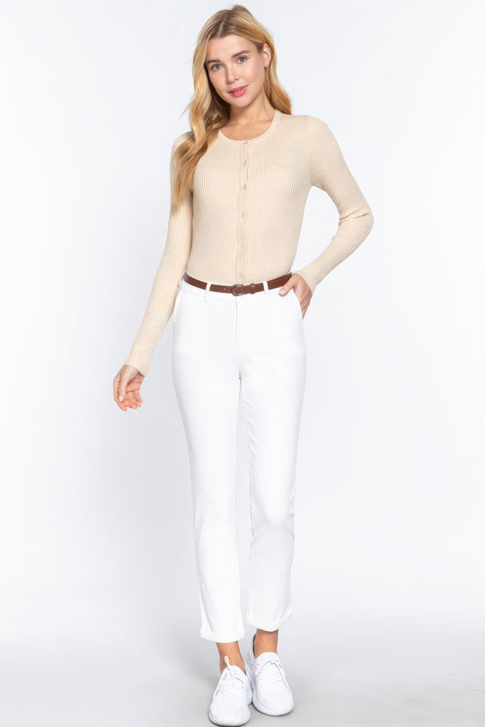 a person wearing white pants and a beige sweater