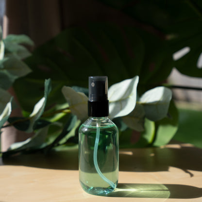 a bottle of green liquid sitting on top of a wooden table